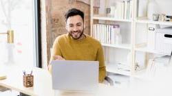 Business man sitting at desk working on computer